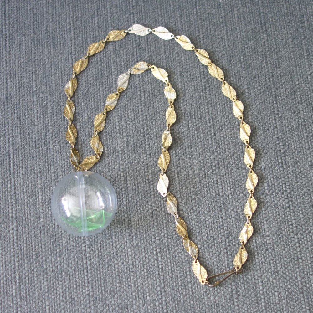 Broken Uranium Glass Inside Plastic Ornament with Metal Necklace